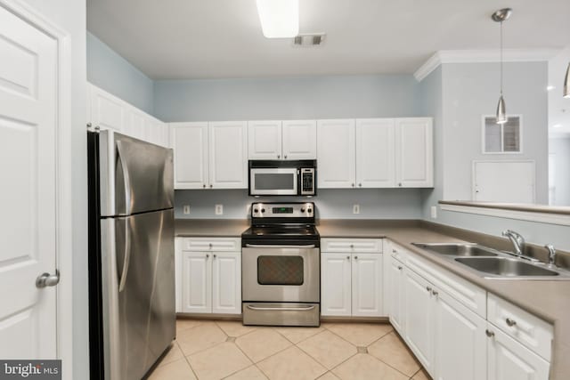 kitchen with decorative light fixtures, white cabinetry, sink, and appliances with stainless steel finishes