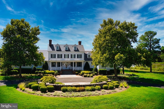 view of front of house featuring a front yard and a porch