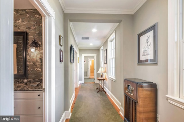 corridor with carpet flooring and crown molding