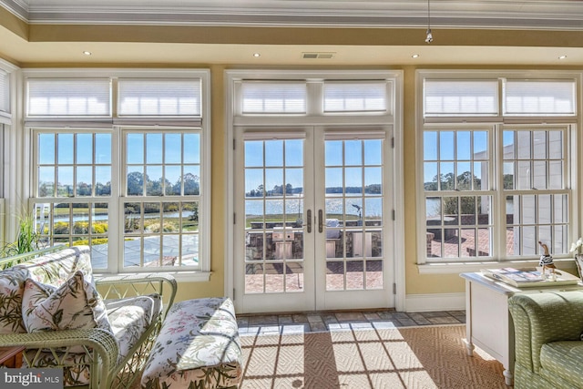 entryway with french doors, plenty of natural light, and ornamental molding