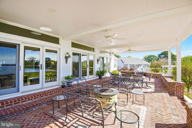 view of patio featuring ceiling fan and an outdoor fire pit