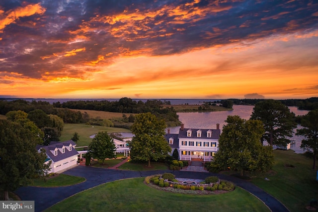 aerial view at dusk with a water view