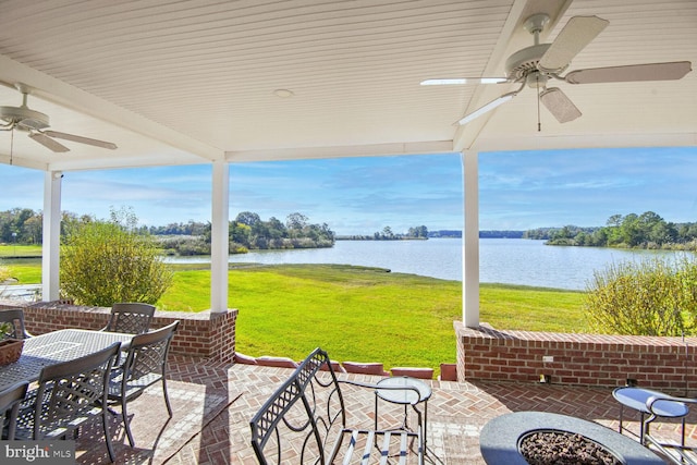 view of patio with ceiling fan and a water view