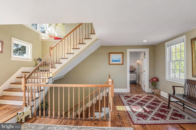 stairway with hardwood / wood-style floors