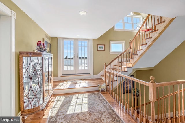 entryway with wood-type flooring and french doors