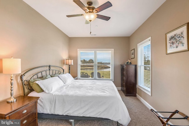 bedroom with carpet flooring, multiple windows, and ceiling fan