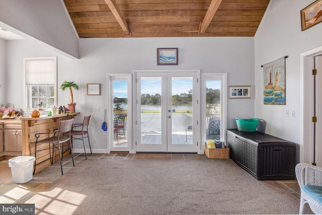 doorway to outside featuring vaulted ceiling with beams, french doors, light colored carpet, and wooden ceiling