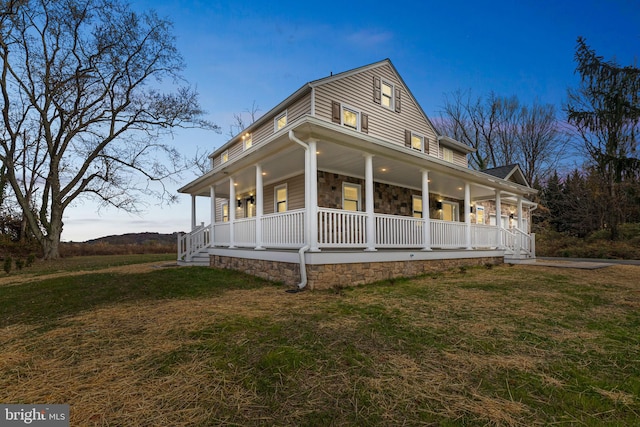 view of front of home featuring a lawn and a porch