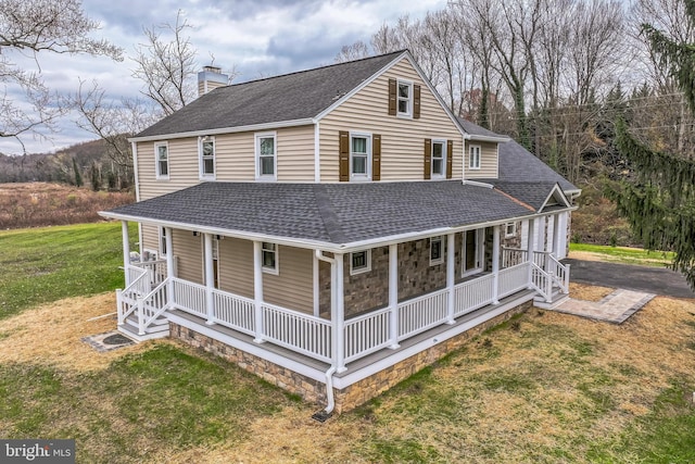 exterior space featuring covered porch and a front lawn