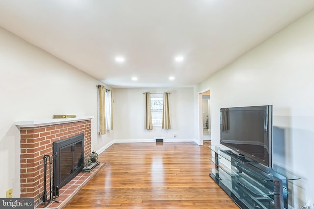 living room with a fireplace and light hardwood / wood-style flooring