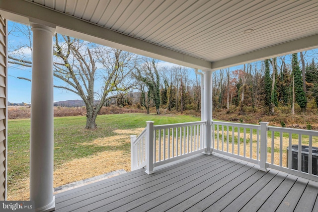 deck featuring a lawn and central AC