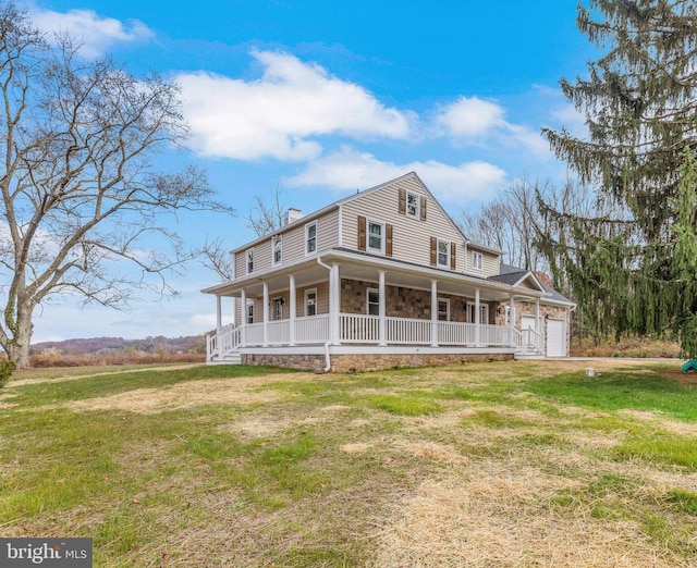 farmhouse-style home with covered porch, a garage, and a front yard