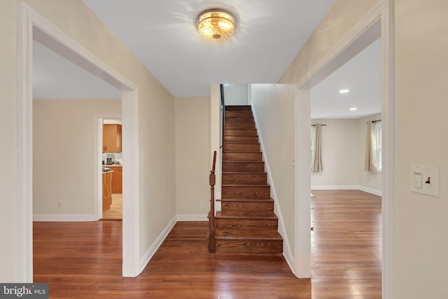 stairway with hardwood / wood-style flooring