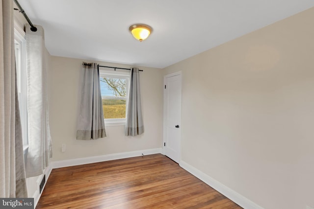 unfurnished room with hardwood / wood-style flooring