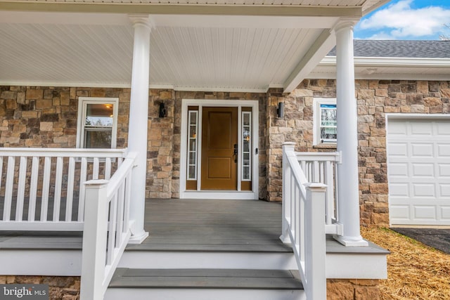 view of exterior entry with a porch