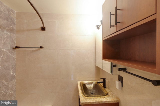 bathroom featuring vanity, tile walls, and backsplash