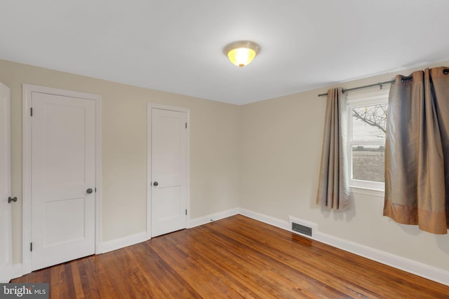 unfurnished bedroom featuring hardwood / wood-style floors