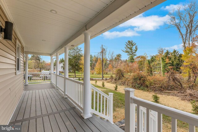 wooden terrace with a porch