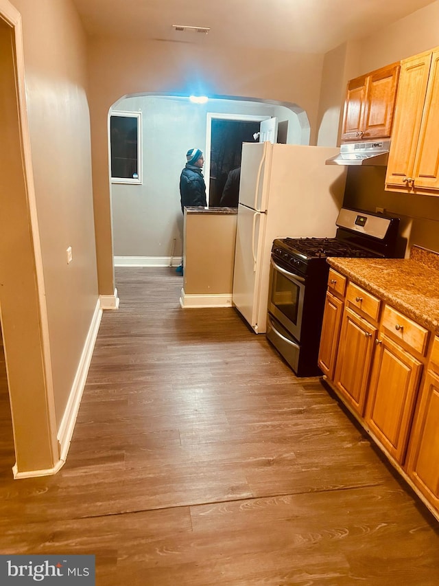 kitchen with light wood-type flooring and stainless steel range with gas stovetop