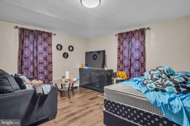 bedroom featuring a textured ceiling and light wood-type flooring