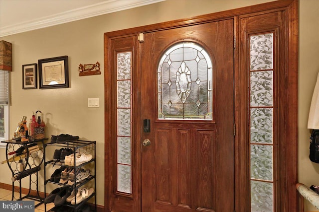 tiled foyer entrance featuring ornamental molding