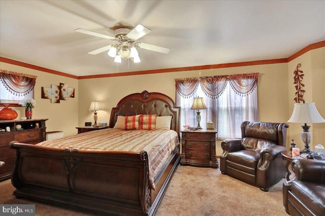 carpeted bedroom featuring ceiling fan and crown molding