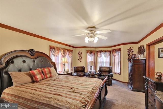 bedroom featuring ceiling fan, crown molding, light carpet, and multiple windows