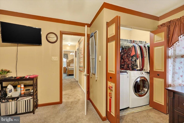 laundry area with light carpet and washing machine and clothes dryer