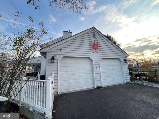 view of garage at dusk