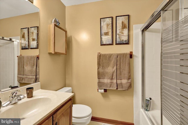 full bathroom with vanity, toilet, and shower / bath combination with glass door