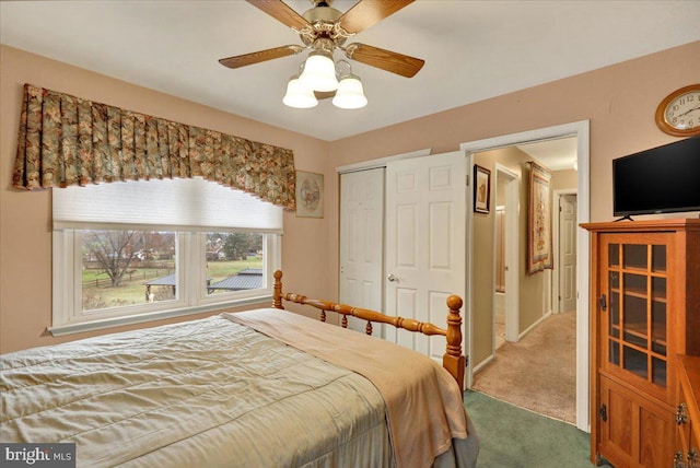 carpeted bedroom with ceiling fan and a closet