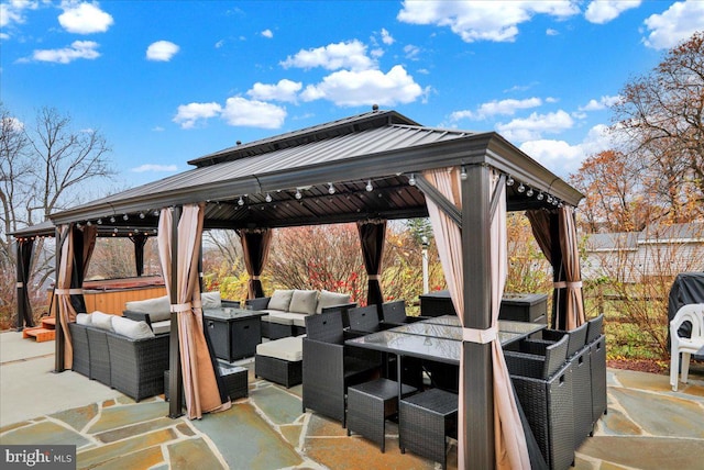 view of patio / terrace with a gazebo, outdoor lounge area, and a hot tub