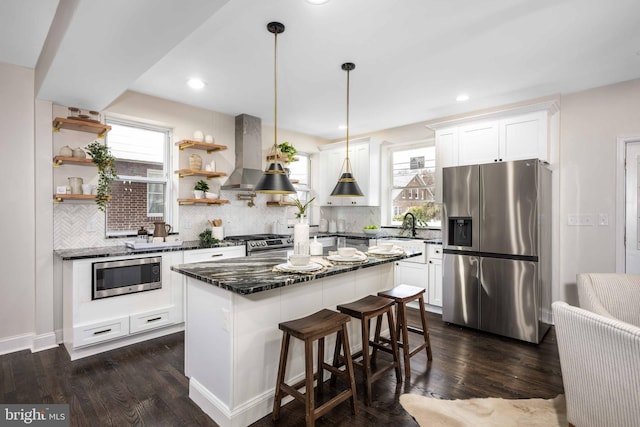 kitchen featuring island exhaust hood, plenty of natural light, a center island, and stainless steel appliances