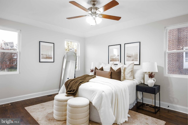 bedroom with ceiling fan and dark hardwood / wood-style flooring