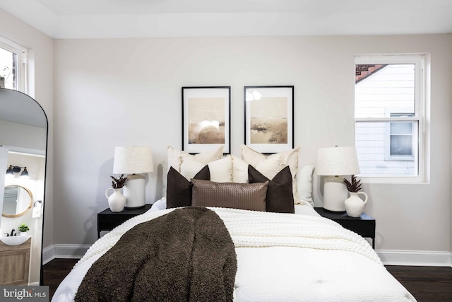 bedroom featuring dark hardwood / wood-style floors and multiple windows