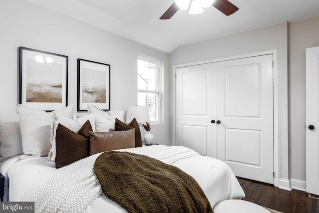 bedroom with a closet, ceiling fan, and dark hardwood / wood-style flooring