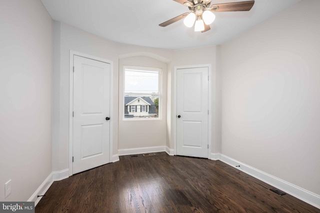 unfurnished room featuring dark hardwood / wood-style floors and ceiling fan