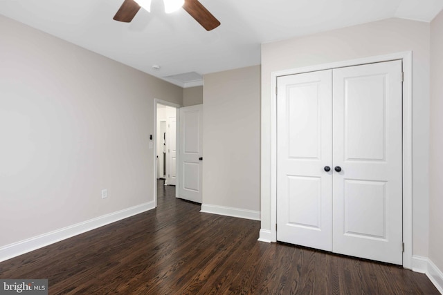 unfurnished bedroom featuring a closet, dark hardwood / wood-style floors, and ceiling fan