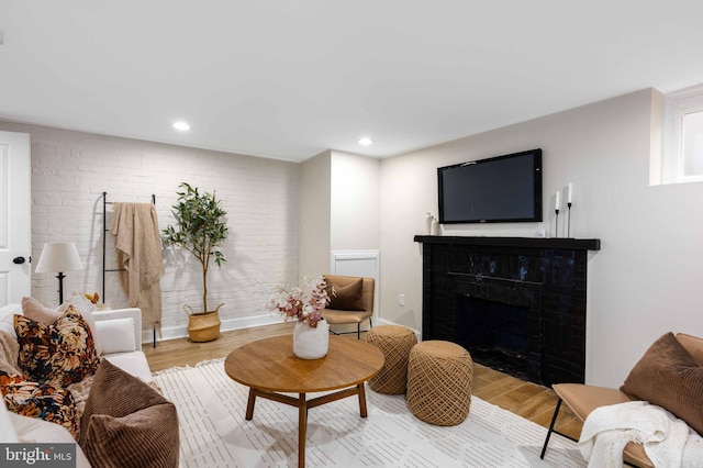 living room with a fireplace and light hardwood / wood-style floors