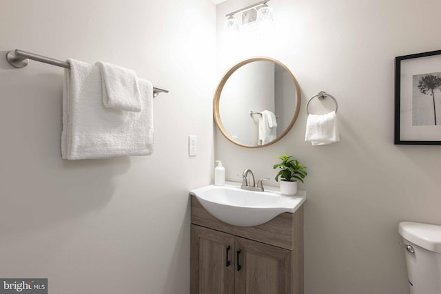 bathroom featuring vanity and toilet