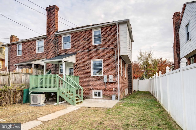 rear view of house with ac unit, a patio, a yard, and a deck