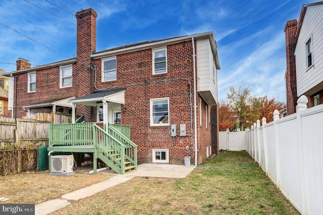 rear view of property with a lawn, ac unit, a patio area, and a deck