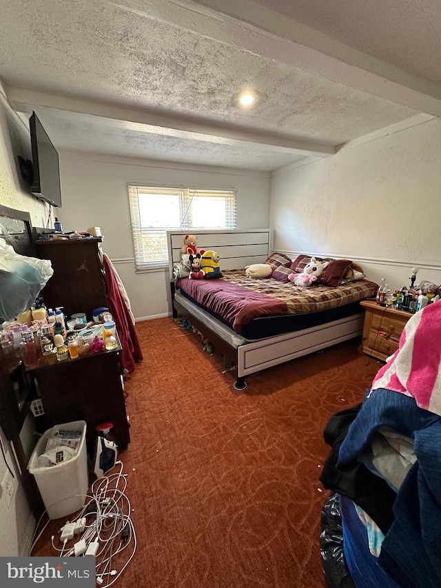 bedroom with carpet and a textured ceiling