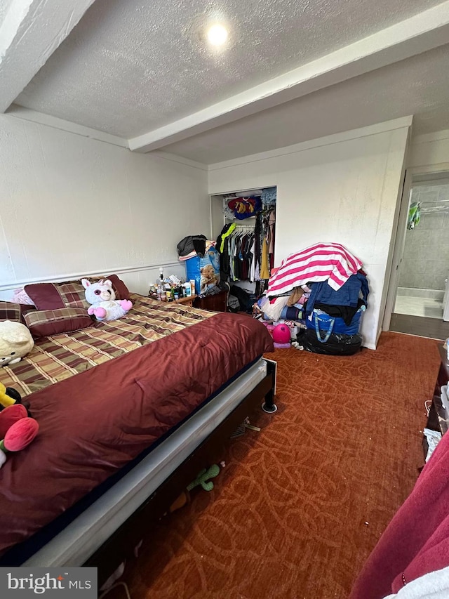 bedroom with carpet and a textured ceiling