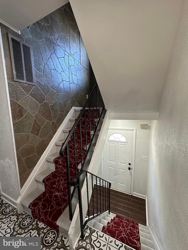 stairway featuring vaulted ceiling