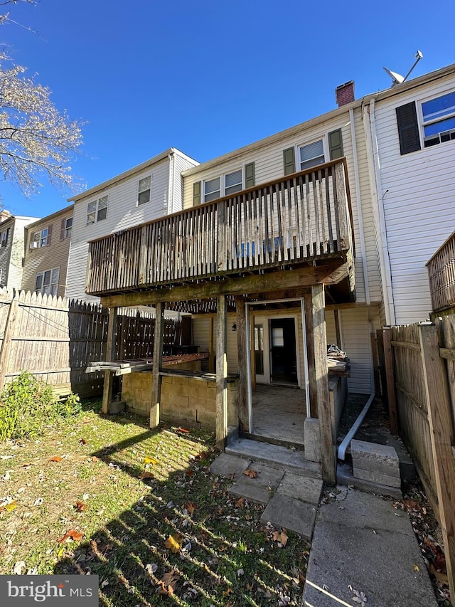 back of house with a wooden deck