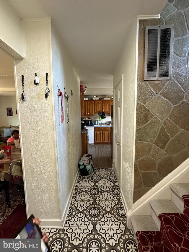 hall with light tile patterned floors