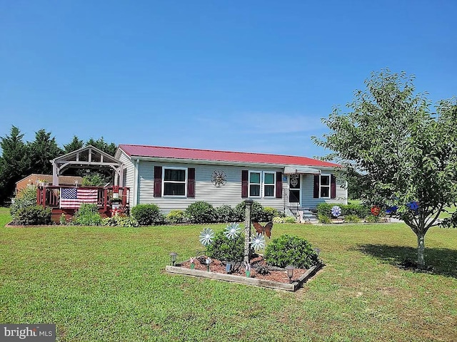 manufactured / mobile home with a gazebo, a wooden deck, and a front lawn