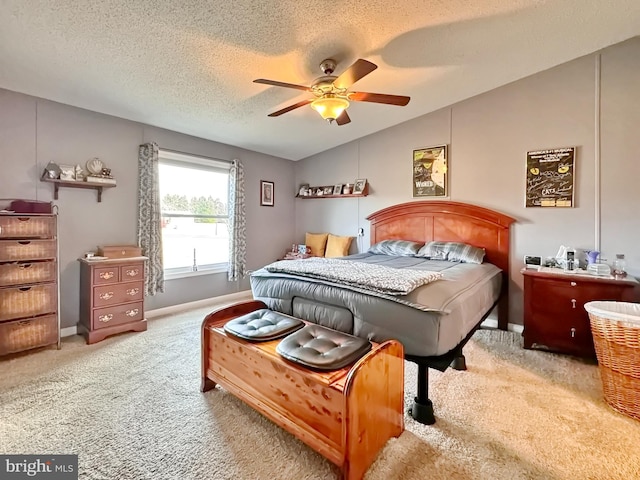 bedroom with carpet flooring, ceiling fan, a textured ceiling, and vaulted ceiling