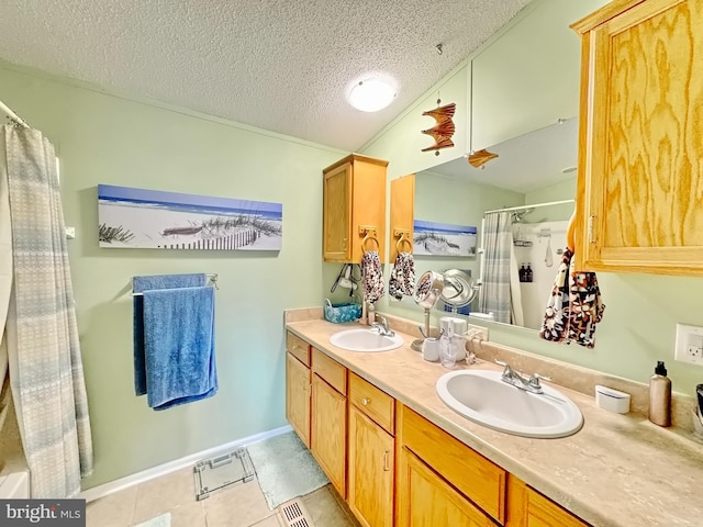 bathroom featuring tile patterned flooring, a textured ceiling, vanity, and a shower with shower curtain